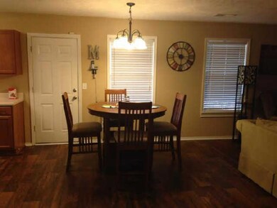 Eat in kitchen with faux hardwood flooring.