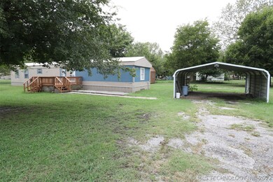 Front of house with large front deck and 2-car car