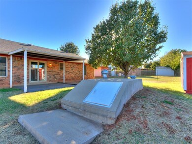 View of storm shelter featuring a yard, a storage 