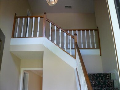 Upstairs landing overlooks foyer.