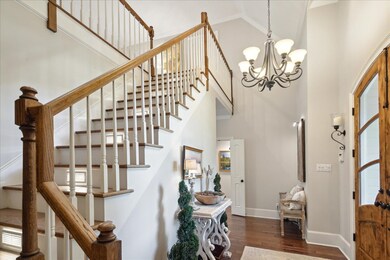 Entrance foyer with an inviting chandelier, high v