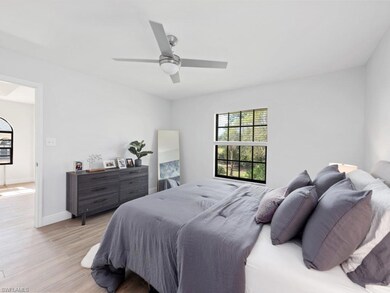 Bedroom with ceiling fan and light hardwood / wood