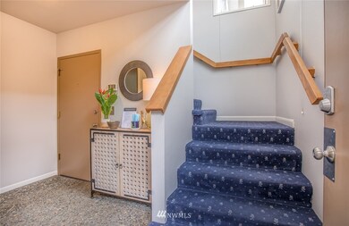 Private entrance from the two car garage into a foyer that also has the front door. Steps up to the living space.