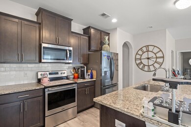 Kitchen with stainless steel appliances, a sink, l