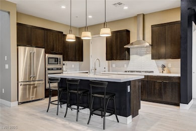 Kitchen featuring visible vents, a breakfast bar,