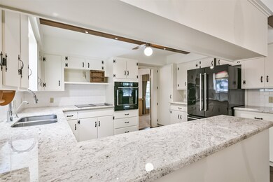 Enter the classy kitchen with granite countertops and new appliances.