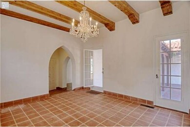 Doors lead to courtyard, exposed beamed ceiling
