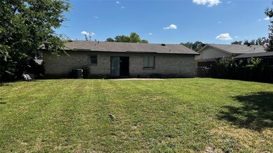 Back of property featuring a yard