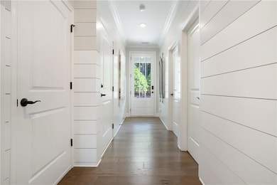 Entryway with ornamental molding and dark hardwood / wood-style flooring