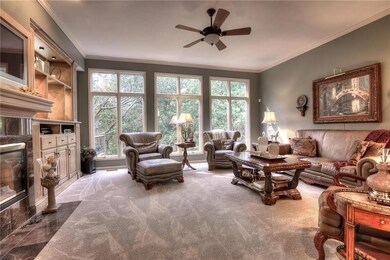 Living room features built-ins and fireplace