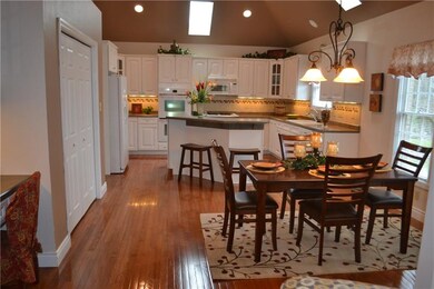 Spacious kitchen with hardwood flooring, high ceil
