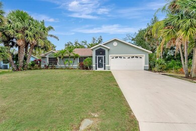Ample driveway space leads to a two-car garage and a screened entryway—practical, polished, and ready to welcome YOU home!