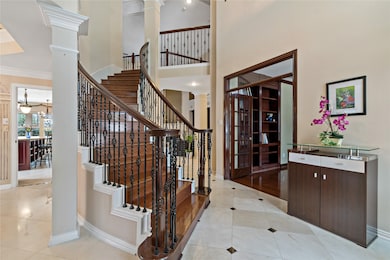 Step into a dramatic two-story foyer that sets the