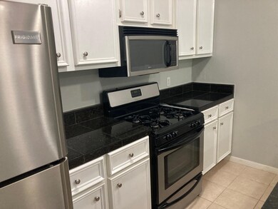 Kitchen featuring light tile patterned floors, wh
