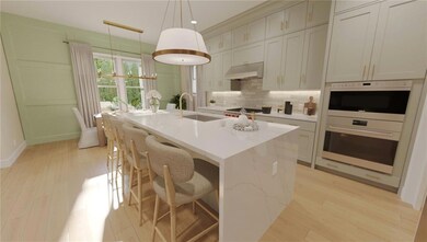 Kitchen featuring a sink, a center island with sin