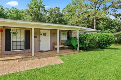 View of front of home featuring covered porch, a front yard, and board and batten siding