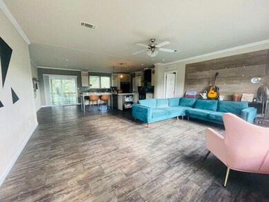 Living room with crown molding, baseboards, ceili