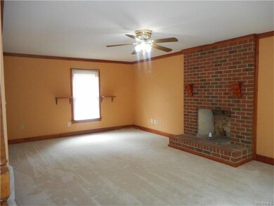 New carpet in the spacious family room with brick fireplace.