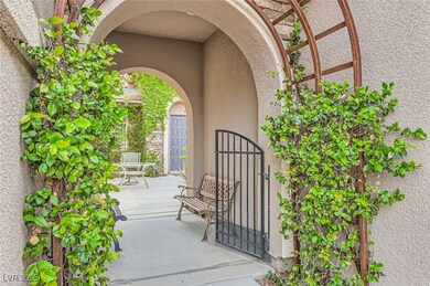Doorway to property featuring a gate and stucco si