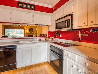 Kitchen with white cabinets and hardwood floors
