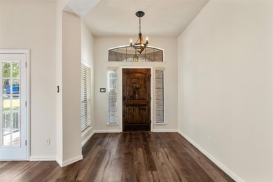 Entryway featuring a notable chandelier, a towerin