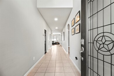 Step inside to a wide, tiled entry hallway that le