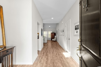 Corridor with light wood-style floors and recessed lighting