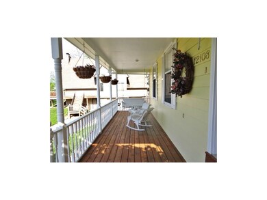 Large front porch with a swinging bench.