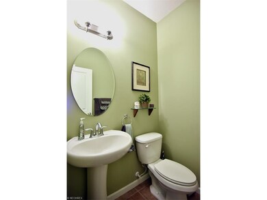 The first floor half bath is bright and cheery w/ 