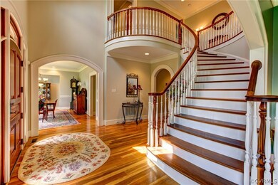 Custom made sweeping mahogany front staircase.