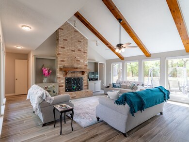 Wall of windows, cedar beams and gaslog fireplace