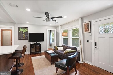 Living room featuring baseboards, ceiling fan, dark wood-type flooring, and recessed lighting