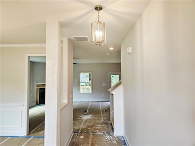 Hall with a chandelier and baseboards