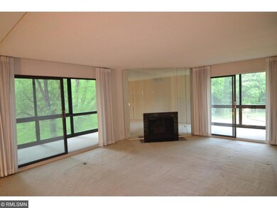 Large living room with gas fireplace and two slidi