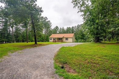 Ranch-style home with driveway and a front lawn