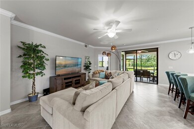 Tiled living area featuring crown molding