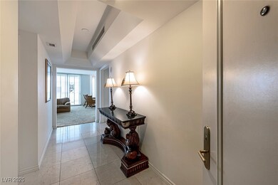 Corridor featuring baseboards and a tray ceiling