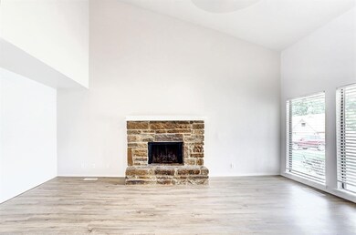 Unfurnished living room with high vaulted ceiling,
