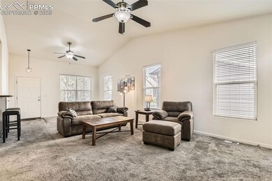 Living area with 2 ceiling fans and vaulted ceiling