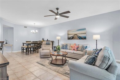 Tiled living room with ceiling fan with notable ch