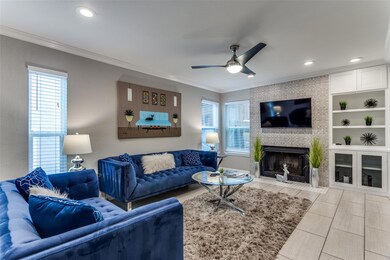 Living room featuring ceiling fan, light tile floo