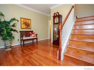 Large entry hall with HW floor and HW stairs.