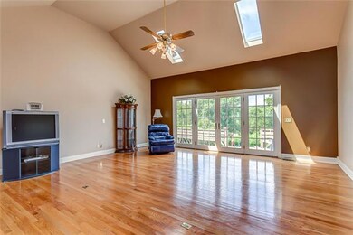 Spacious Great Room with two sets of French doors, 2 skylights, and a cathedral ceiling.