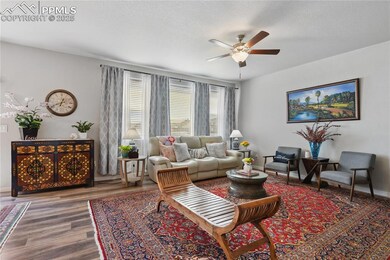 Living area featuring a ceiling fan, LVP Flooring