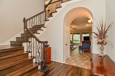 The hardwood floors extend up the stairway. Note the iron balusters.