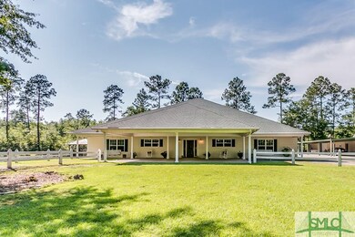 Front of the house with drive under portico.