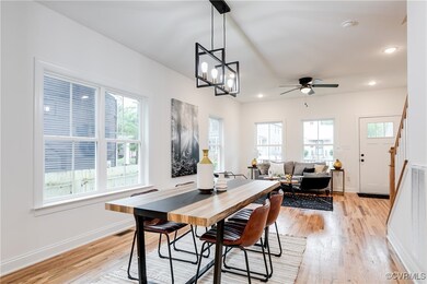 Dining space with ceiling fan with notable chandel