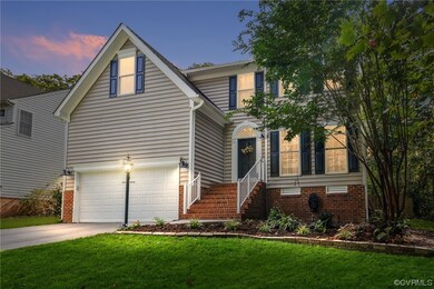 View of front of house featuring a yard and a gara