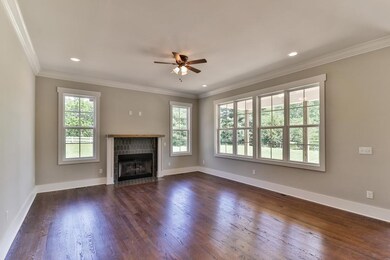 Open floor plan with great room opening up into the kitchen.  Crown Molding. Gas fireplace with rustic mantle and ornate tile work.