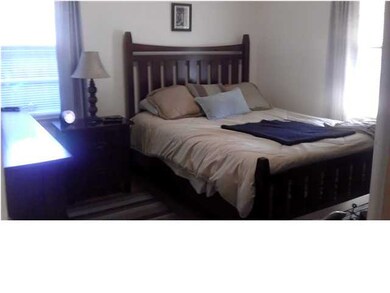 Bedroom features lovely hardwood floor